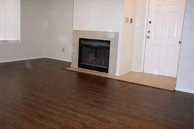 Living area with gas fireplace. Notice tiled entry