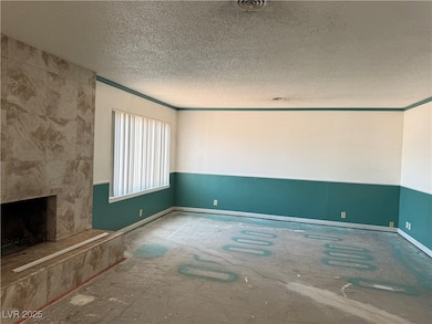 Unfurnished living room with a textured ceiling, a