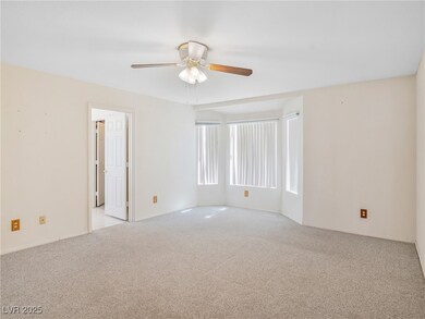 Carpeted empty room with ceiling fan