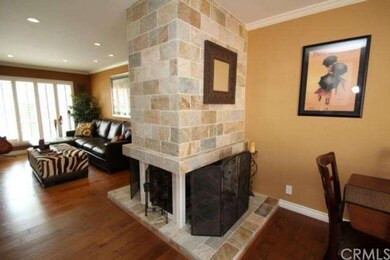 3 sided fireplace with gorgeous travertine