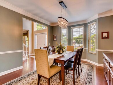 Formal dining room with chair rail, double wide crown molding and new windows. 