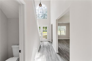 Foyer entrance with wood finished floors and baseboards