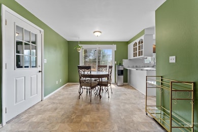 Dining space featuring stone finish floors and baseboards