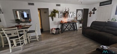 Living room featuring wood finished floors and a textured ceiling