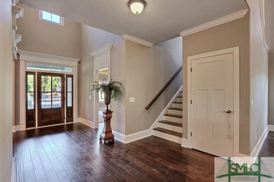 2 Story Foyer Entrance ~ Hard Wood Floors ~ Custom Moldings Throughout