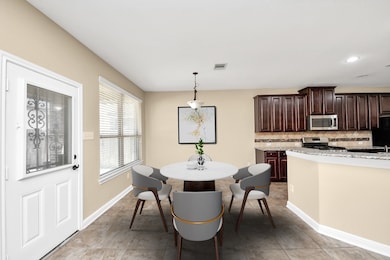 Bright dining area with tile flooring and a round