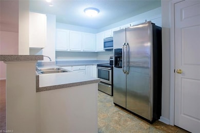 Kitchen with beautiful refrigerator which comes with the unit.