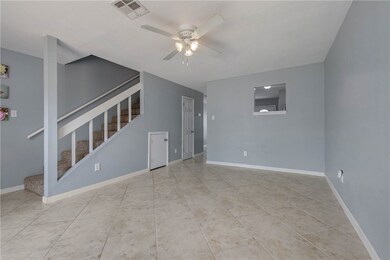 Unfurnished living room with ceiling fan, stairway