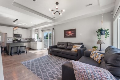 Living area featuring a chandelier and light wood-type flooring