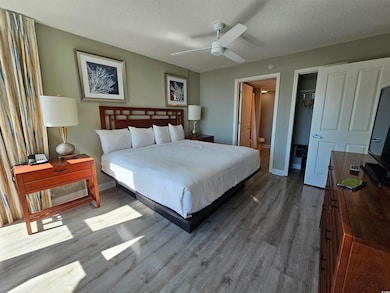 Bedroom featuring a textured ceiling, a spacious c