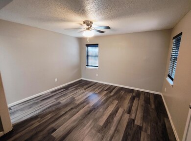 Spare room featuring dark wood-style flooring, cei