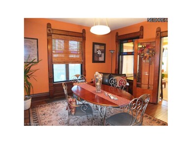 Large formal dining room with hardwood floors.