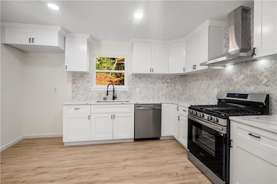 Kitchen featuring light wood-style flooring, appli