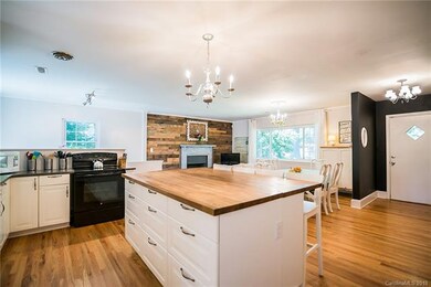 The kitchen features granite counter tops and ador