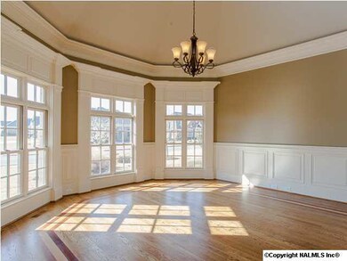 Elegant study with trey ceiling, rope lighting and chair rail.
