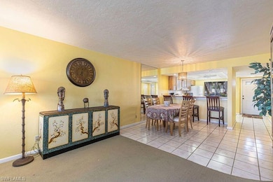 Tiled dining space with a textured ceiling