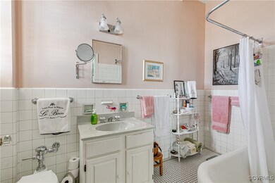 Bathroom with vanity, tile walls and  backsplash