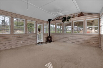 Family room has coved ceiling, two ceiling fans, a