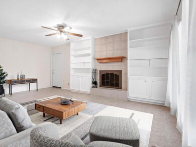 Living area with built in features, ceiling fan, 