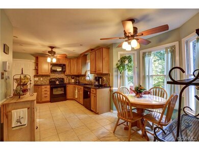 Eat in area with dual ceiling fans and bay window