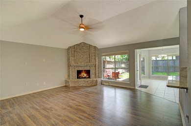The living room has huge ceilings, a gas-burning f