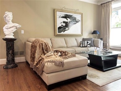 Living area featuring crown molding and wood finis