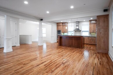 Large family room open to kitchen and dining area.