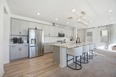 Abundance of cabinetry with upgraded backsplash.  Elongated countertop for cooking prep, dining and extra seating.
