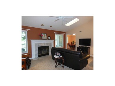 Living room features vaulted ceiling, skylights an