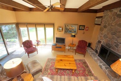 Hardwood floors & a wood-burning fireplace make th
