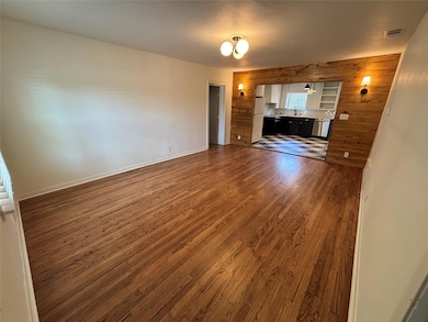 Unfurnished living room with dark wood finished f