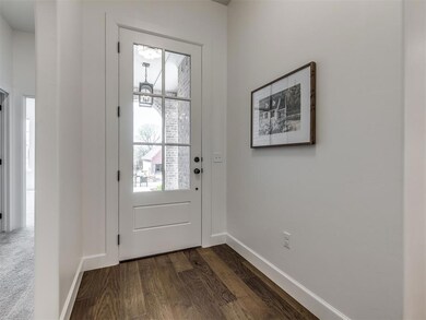 Doorway to outside with dark hardwood / wood-style
