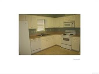 Kitchen features lots of cabinets and counter spac