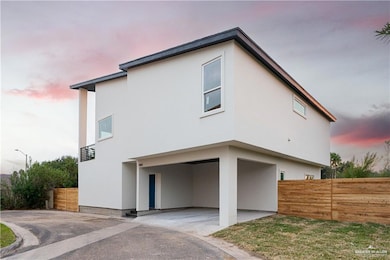 View of property exterior featuring stucco siding, driveway, and a patio