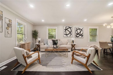 Living area with baseboards, dark wood-style floor