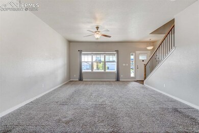 Unfurnished living room featuring ceiling fan, a t