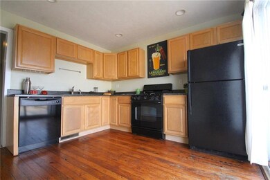 Updated kitchen has original refinished wood floor