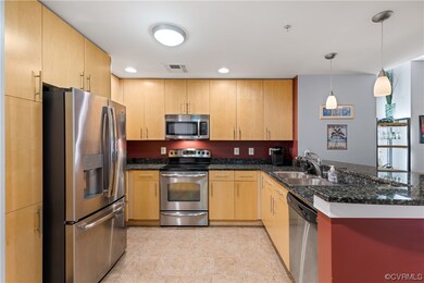 Kitchen with recessed can lighting and granite cou