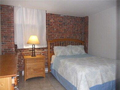 Second bedroom with exposed brick.