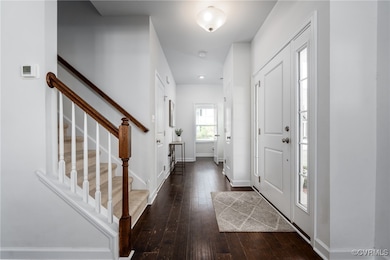 Foyer Leading to Powder Room and Door to Garage