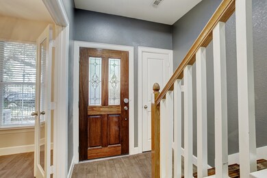 Beside the front door, with its etched glass, is a