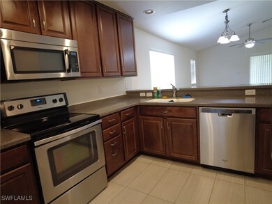 Kitchen featuring light tile patterned flooring, c