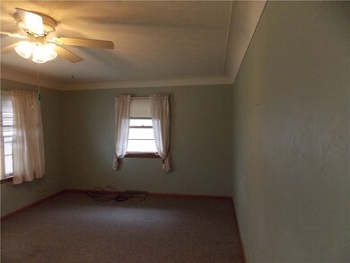 Living room with cove ceiling. Hardwood flooring u