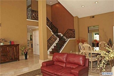 Entry with vaulted ceilings and beautiful wrought 
