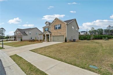 Traditional-style home featuring a front yard, an 