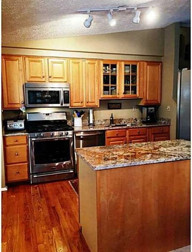 Kitchen. Other view of kitchen, as seen from the dining room.  Jennair appliances/upgraded cabinets/granite counters