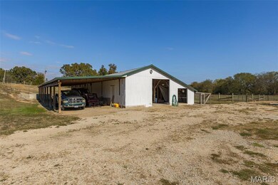 View of pole building with a rural view