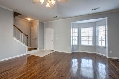 Another view of the living room. The half bath is just off of this room. The living room also opens into the dining room, and has a look through 