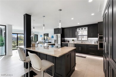 Kitchen with backsplash, light stone countertops,
