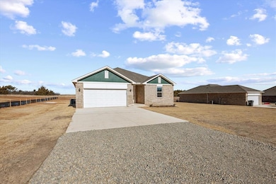 View of front of house with concrete driveway, a g